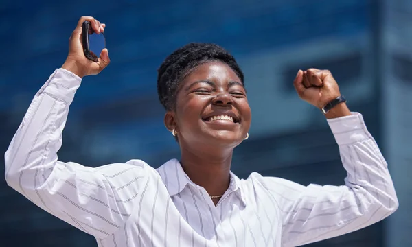 Winner, celebration and black woman in business happy after winning a corporate achievement outside in summer. Young African female worker excited, smile and hired after successful job promotion.