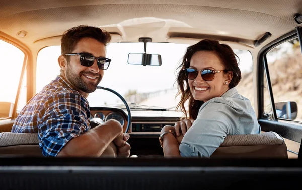 Youll never regret a road trip. Rearview portrait of an affectionate couple enjoying a summer road trip