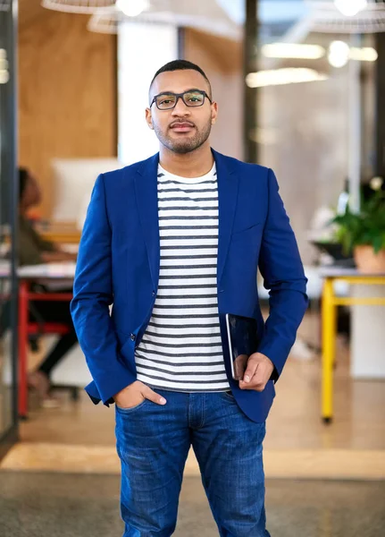 Its my turn to success. a handsome young designer standing in his office