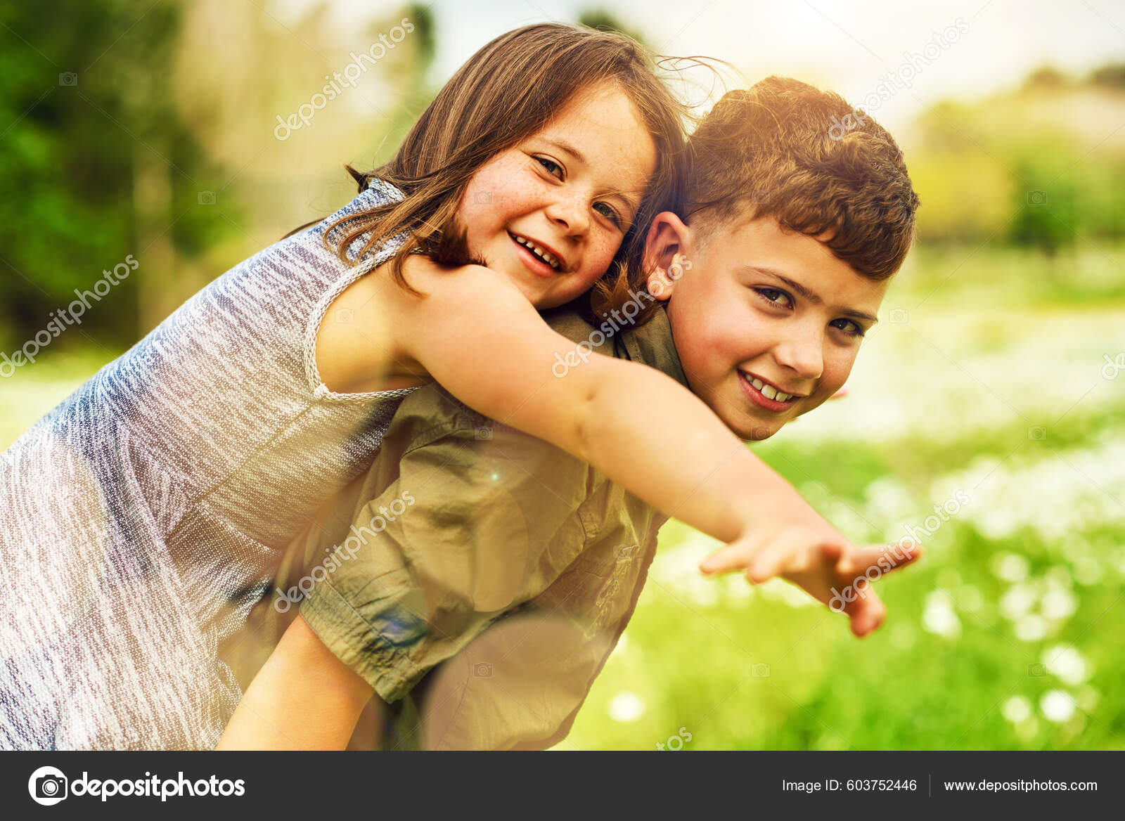 Young girl carrying sister giving piggyback ride Stock Photo