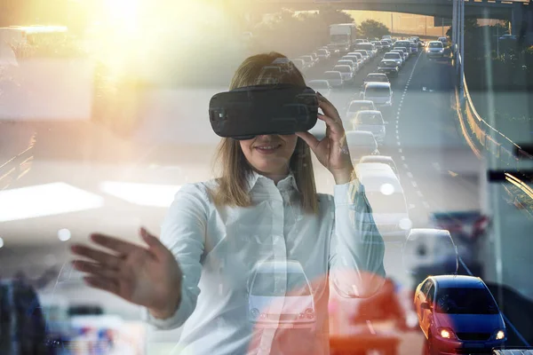 Technology brings vision to her business. Multiple exposure shot of a young businesswoman wearing a VR headset while working alone in her office