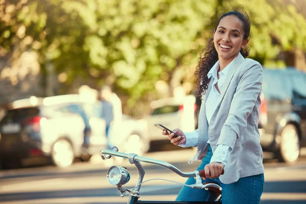 Business woman, bicycle and taking a mobile break outdoors in the street. Working lady in business travels with sustainable transport. Carbon neutral worker enjoys exercise and bike ride outside