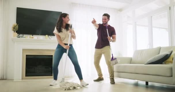 Couple Singing Dancing While Cleaning Living Room People Doing Housework — 图库视频影像