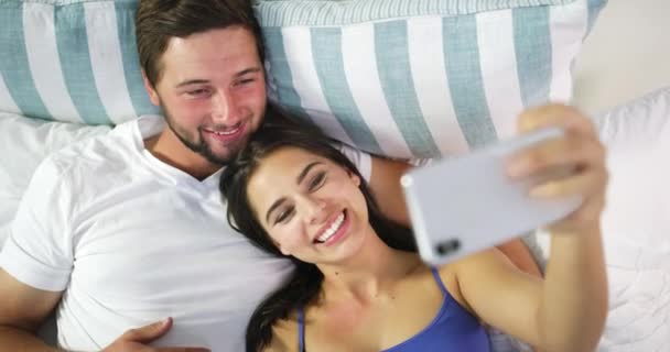 Couple Love Taking Phone Selfie Portrait While Relaxing Bedroom Together — Stockvideo
