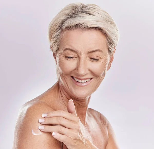 Skincare cream, naked and senior woman mockup studio background. Self care, anti ageing and beauty wellness for healthy body. Mature lady happy with glowing skin pamper application routine