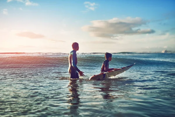 Three most important things in life, surf, surf and surf. two young boys out surfing