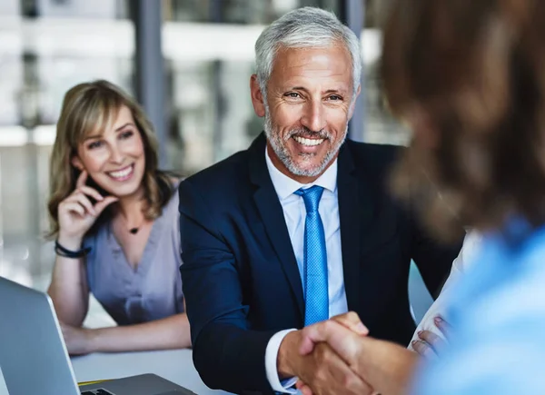 Bringing the best on board. businessmen shaking hands during a meeting at work