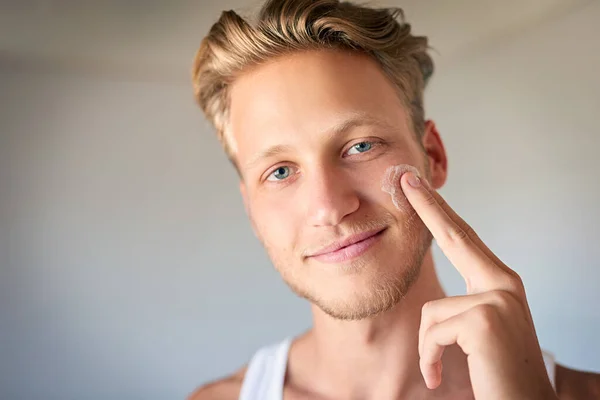 Keep Skin Moisturized Protected Young Man Applying Moisturizer His Face — Stockfoto