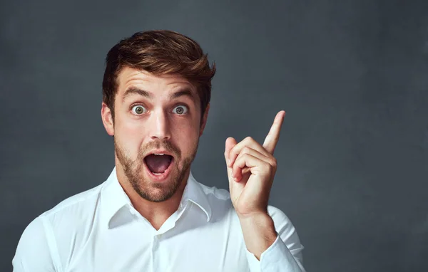 Mean Studio Portrait Handsome Young Man Pointing Excitedly Copyspace Dark — Zdjęcie stockowe