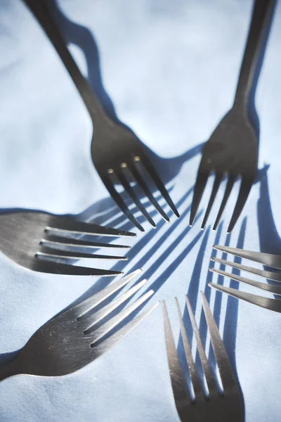 Restaurant service and silver group of fork display on a table for catering service or food industry. Top zoom view of clean, metal or steel cutlery, kitchenware and kitchen tableware equipment.