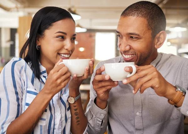 Romance, fun and coffee date with happy couple at a cafe or restaurant, bonding, in love and talking. Young boyfriend and girlfriend enjoying their relationship and free time on the weekend together.