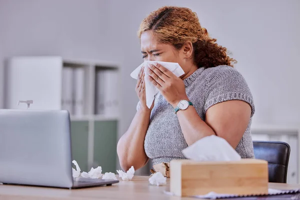 flu, covid and sick corporate employee suffering with a cold or flu, working on laptop, blow nose or sneezing in an office. Young assistant experience allergy, sinus, illness or disease symptoms.