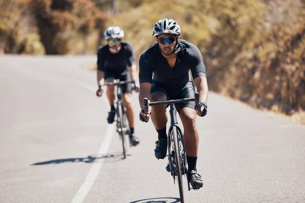 Fitness man cycling bike on mountain road for cardio exercise, sports wellness and energy workout in competition race. Strong, motivation and healthy professional athlete in bicycle training gear.