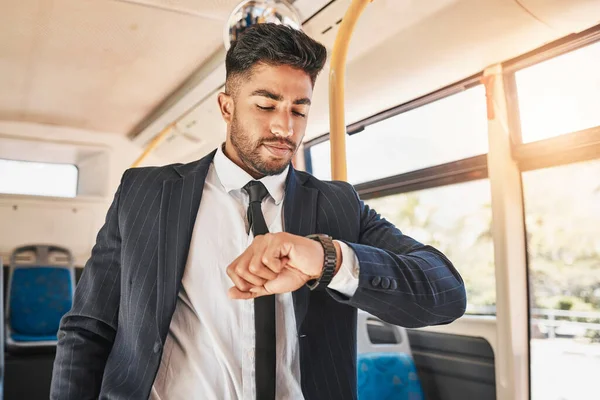 Business man on bus, travel time and morning transport to work, office or meeting. Young entrepreneur, corporate worker and suit employee check watch clock for good time management on morning commute.