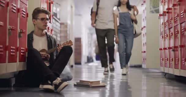 Student Playing Ukulele School Bully Walking Him Sitting Floor Locker — Stock Video