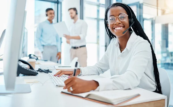 Contact us, crm and online support by call center agent writing note and help customer in office. Smiling black operator enjoy communication and giving expert advice, being friendly and professional.