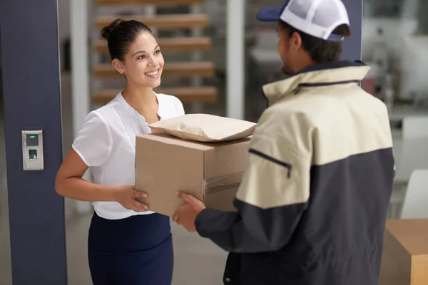 I appreciate your swift service. a courier making a delivery to a businesswoman at her office