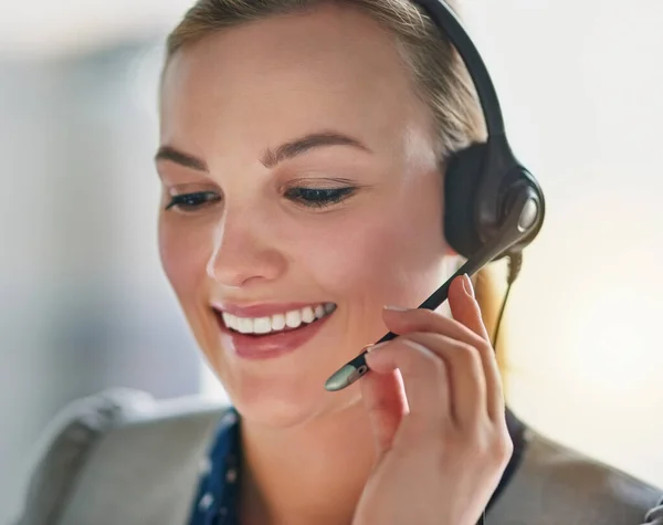 Giving every call her undivided attention. an attractive young woman wearing a headset in the office