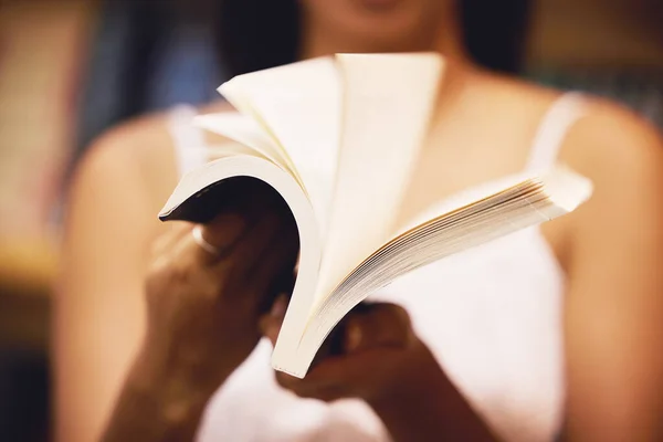 Hands reading books, paper and page in library, bookstore or home for learning, studying and education. College student, woman and academic with literature story, literacy and knowledge research.