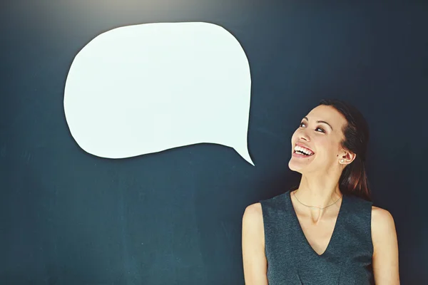 Alone with her thoughts. a young woman posing with a speech bubble against a gray background