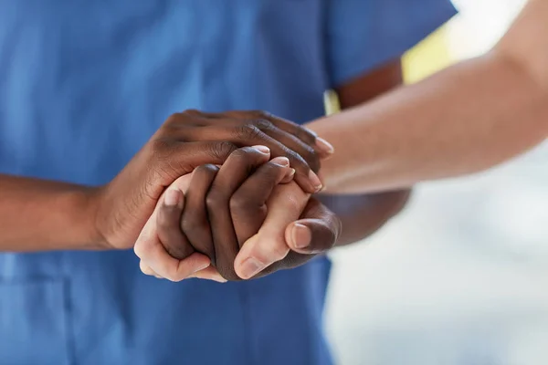 Offering a patient the care and comfort they need. Closeup shot of a medical practitioner holding a patients hand in comfort