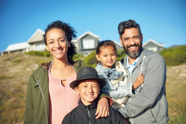 The happiest moments in life are spend with family. a family of four spending the day outdoors