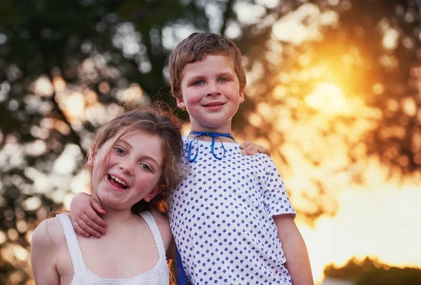 Being a big brother is better than being a superhero. a little boy and his sister standing outside