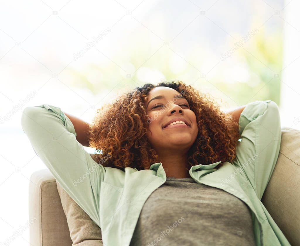 Naps are the best part of her weekend. an attractive young woman resting on her sofa at home