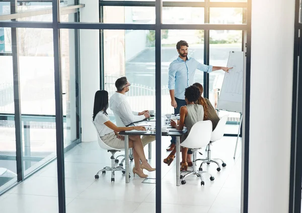 Taking business to the next level. a businessman giving a presentation to his colleagues in a modern office