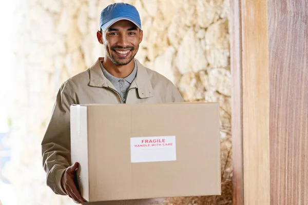 Delivered on time, every time. Cropped portrait of a handsome young man delivering your package
