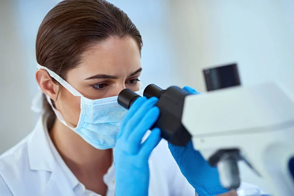 Gaining deeper insights to help develop a cure. a female scientist working alone in the lab