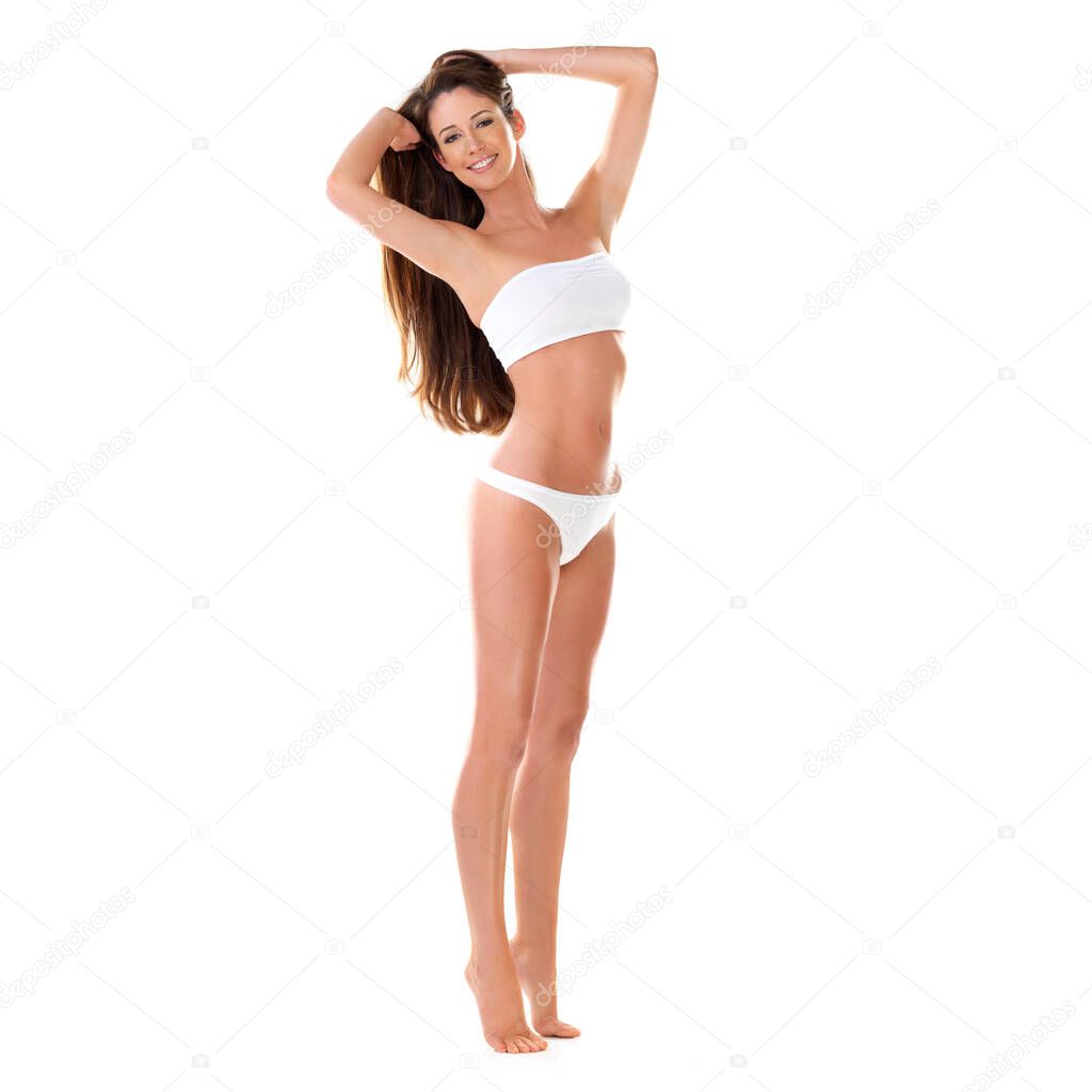 Bikini beautiful. Studio portrait of a beautiful young brunette woman in a white bikini with her hands in her hair isolated on white
