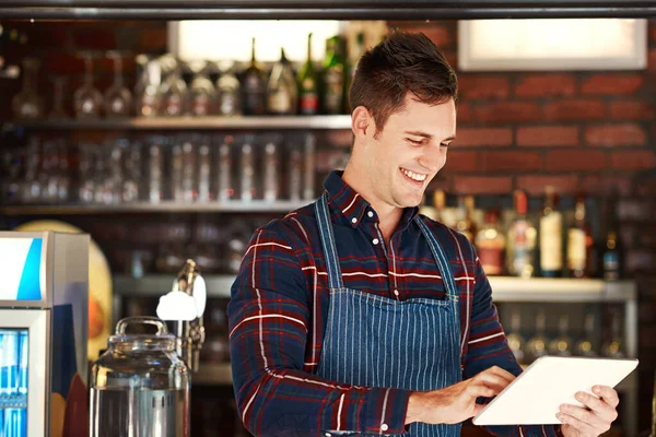 The more people know about your business, the better. a restaurant owner using a digital tablet