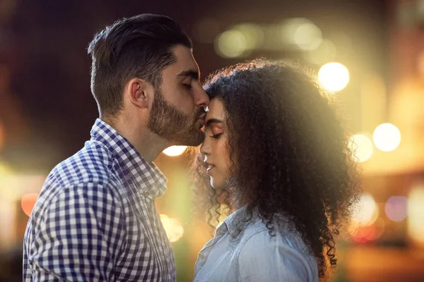 The perfect end to the perfect night. an affectionate young couple out on a date in the city