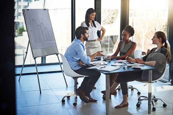 The young guns of the company in action. a group of businesspeople having a meeting in a boardroom