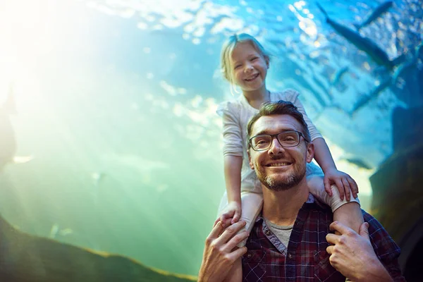 Were thinking of getting some pet fish now. Portrait of a father and his little daughter enjoying an outing to the aquarium