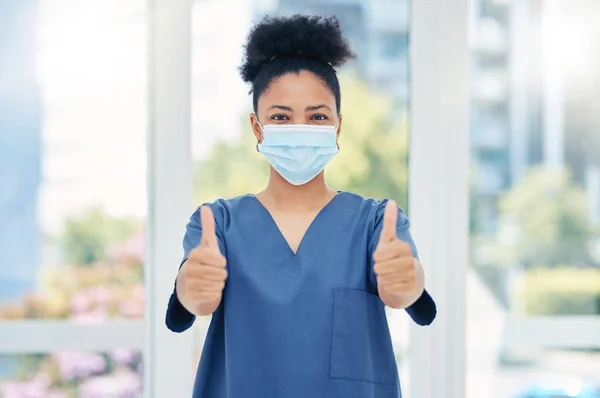 Thumbs up nurse, doctor and surgeon in covid hospital, clinic and surgery for healthcare success, trust and support. Portrait of medical worker with hand emoji for motivation, agreement and good news.
