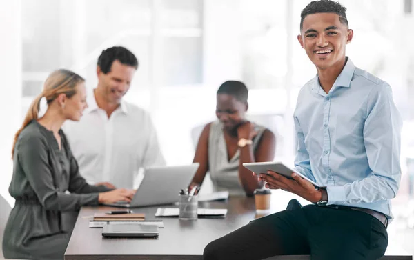 Portrait of a happy businessman smile with a tablet in a team planning meeting at work. An employee in an office with his team as they discuss strategy or plans, and strategies in a corporate office.