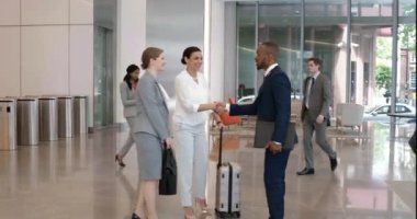 Handshake, business or airport travel for corporate worker meeting, greeting or in welcome with women leadership. Diversity, teamwork or partnership for crm, b2b or global deal with employee in hotel.