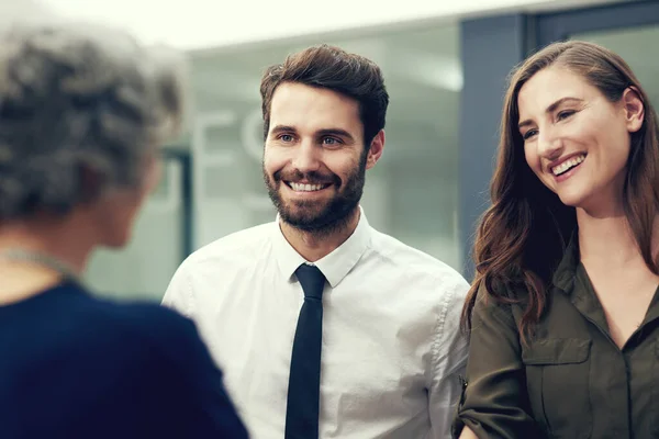 Do better business with the right people. a group of businesspeople having a discussion in an office