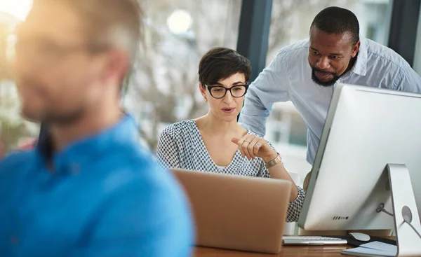 Theres just one thing I need you to check...two businesspeople working together in the office