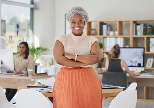 Innovation, leadership and a proud black business woman standing in power in a corporate office. Happy African American leader excited by successful goal management with diverse female employees.