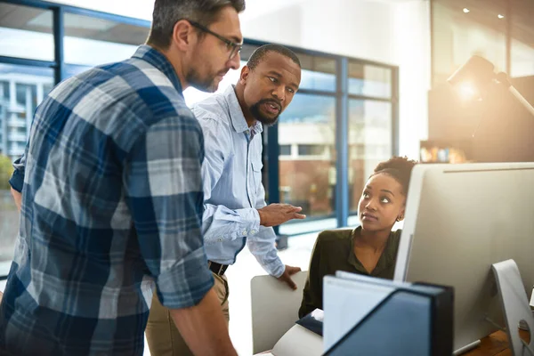 They can do more together. three businesspeople working around a computer in the office