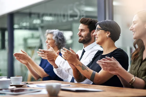 Theyre really impressed. a group of businesspeople applauding together in an office