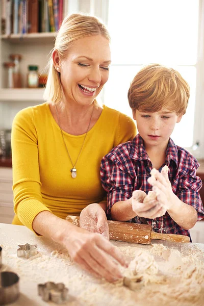 Baking using Moms secret recipe. a mother and son baking together at home