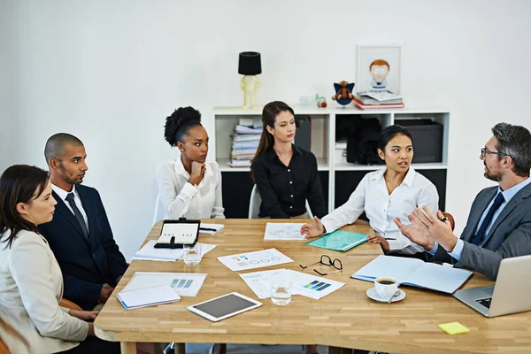 Teamwork is a good way to achieve success. a group of businesspeople meeting in the boardroom