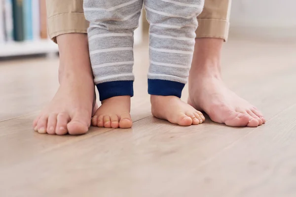 Taking baby steps together. a mother and her baby boys feet together