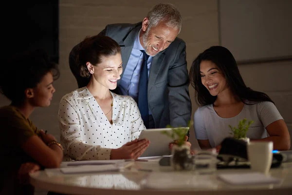 They have a plan at last. a group of colleagues working late in an office