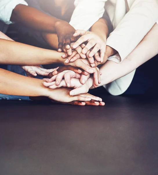 We know we can count on each other. unrecognizable businesspeople joining their hands together in unity