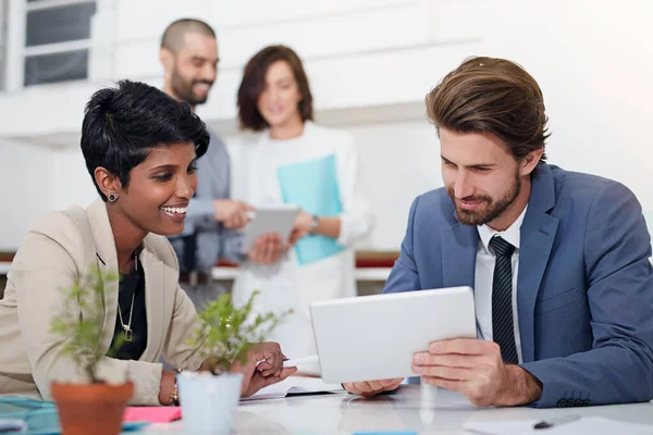 Lots of ideas are flowing here. businesspeople using digital tablets in an office meeting